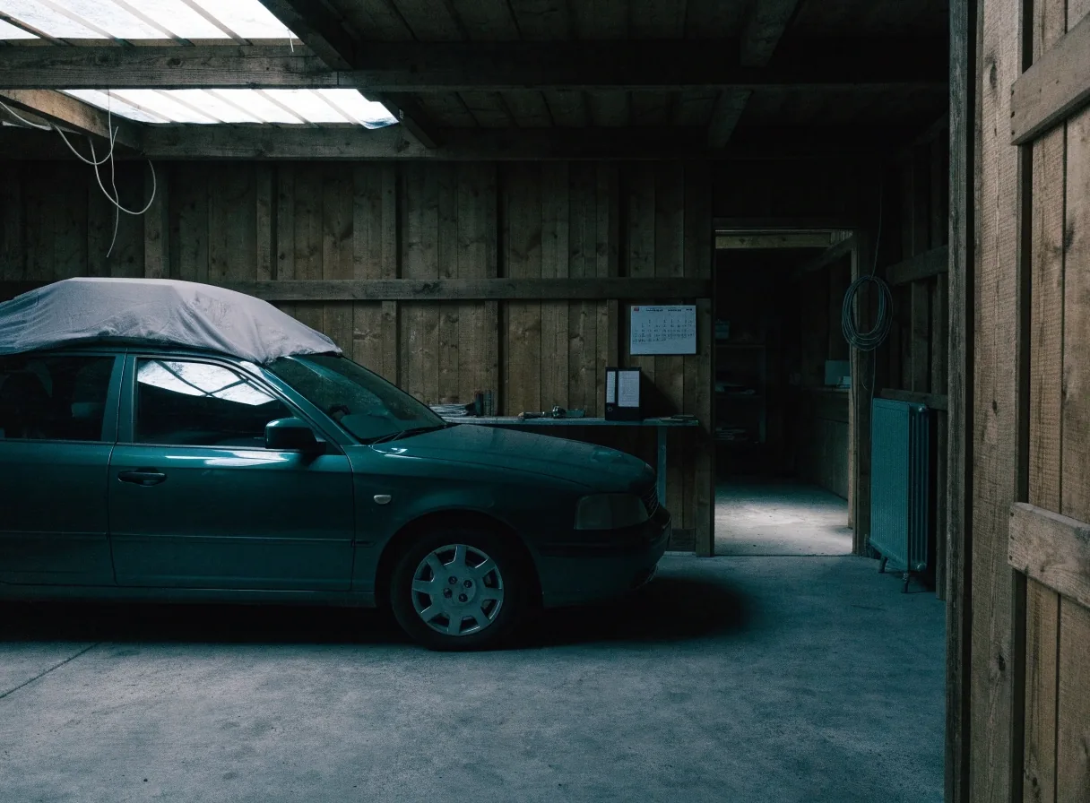 A vehicle stored long term in a garage with its paperwork kept nearby